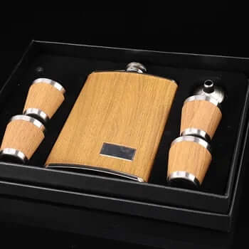 Wooden hip flask set with funnel and stainless steel cups, elegantly presented in a black box for stylish adventures.