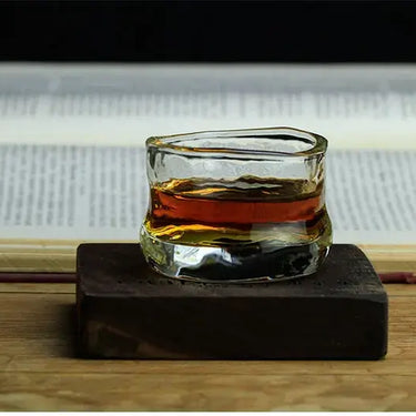 Limited Collection Edo Glass 65ml on wooden box in front of an open book.