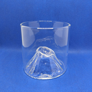 EDO Fuji whisky glass with Mount Fuji inspired design by Liu Siyu against a blue background.