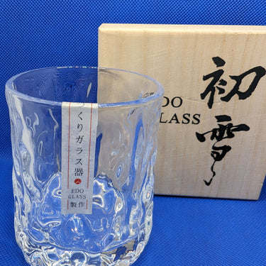 Japanese style thick heavy whisky glass with unique hammer design in front of Edo Glass box.