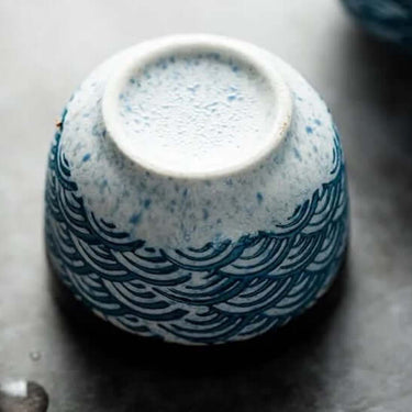 Close-up of ceramic sake cup from Japanese Waves Sake Set featuring traditional blue wave design.