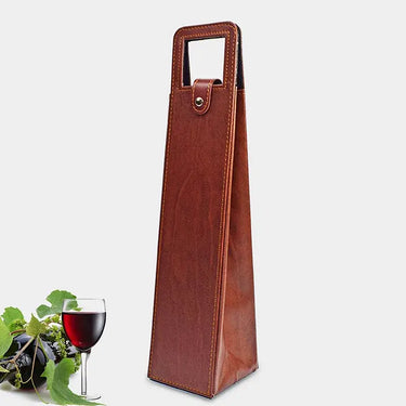 Elegant wine bottle bag in faux leather and flocked fabric with a glass of red wine and grapes in the background.