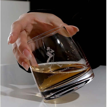 Elegant Johnnie Walker whisky glass held in hand, showcasing premium crystal design for whisky enthusiasts.