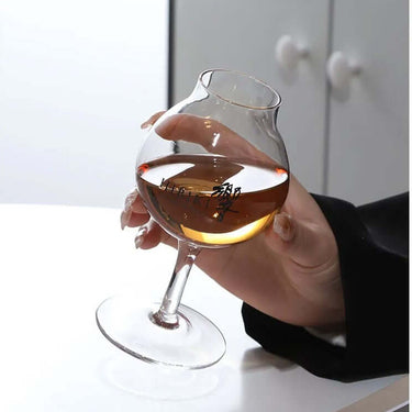 Hibiki Professional Blender Whisky Glass held by a person, showcasing its elegant design and whiskey contents.