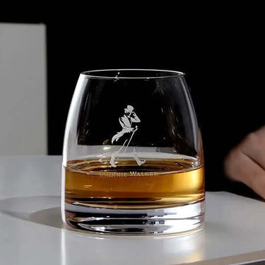 Private Collection Johnnie Walker Whisky Glass with whisky on table, showcasing elegant crystal design.