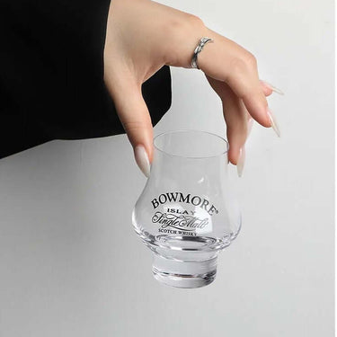 Hand holding Bowmore Single Malt Scotch Whisky Sniffer Glass for a perfect drinking experience