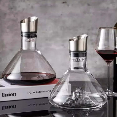 Elegant European transparent lead-free crystal decanters on a table with a glass of red wine.