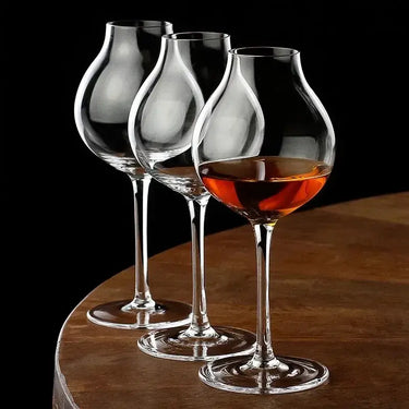 Three British Blender's Scotch Whisky Tasting Glasses on a wooden table, showcasing elegant crystal design and sophistication.