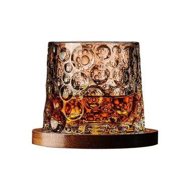 Bubbles glass with bubble pattern and whisky on a wooden base offers a stylish, immersive drinking experience.