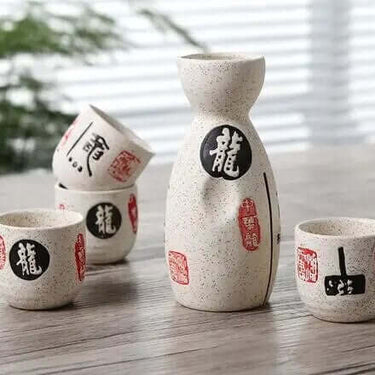 Vintage Ceramic Sake Pot Cups Set with Japanese Calligraphy on a Wooden Table